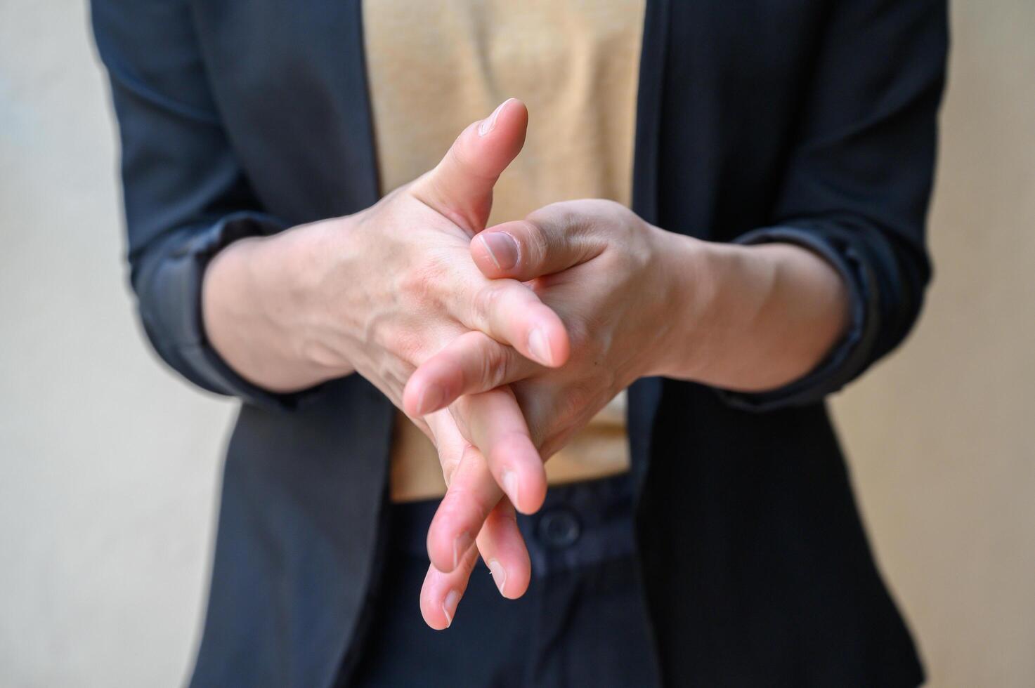 Cropped shot of woman showing hand washing techniques by rub between fingers after using sanitizer gel. photo