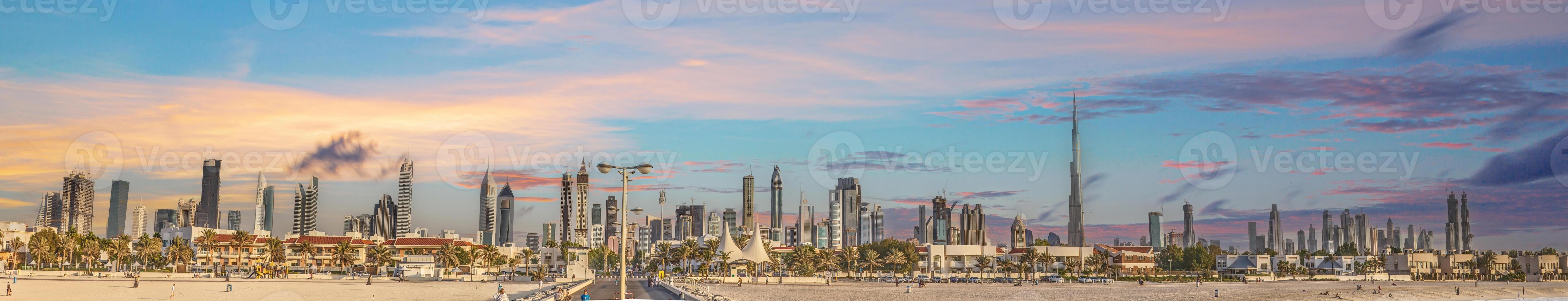 Panoramic image of the illuminated skyline of Dubai at dusk after sunset photo