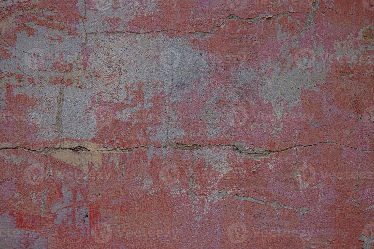 Aged and cracked textured surface. Weathered pink wall with cracks and patina. A great rustic vintage background for graphic design, web and digital art. photo