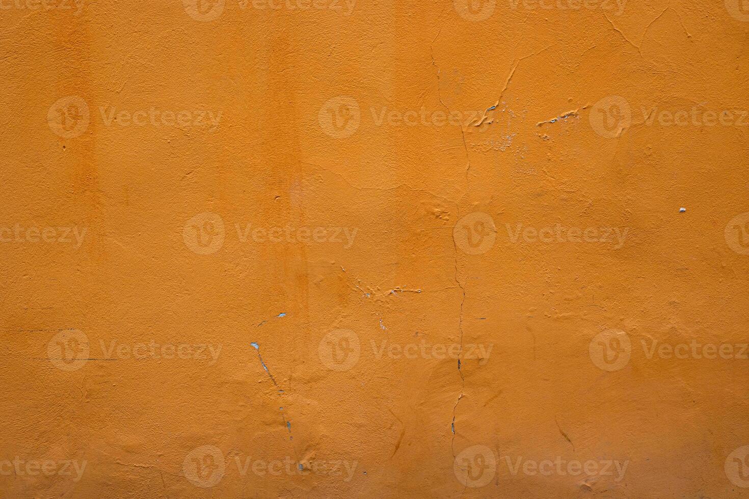 Closeup of an orange wall showcasing its texture and natural imperfections, perfect for background and design projects, Vertical mage shows urban decay with its rustic and vibrant elements photo