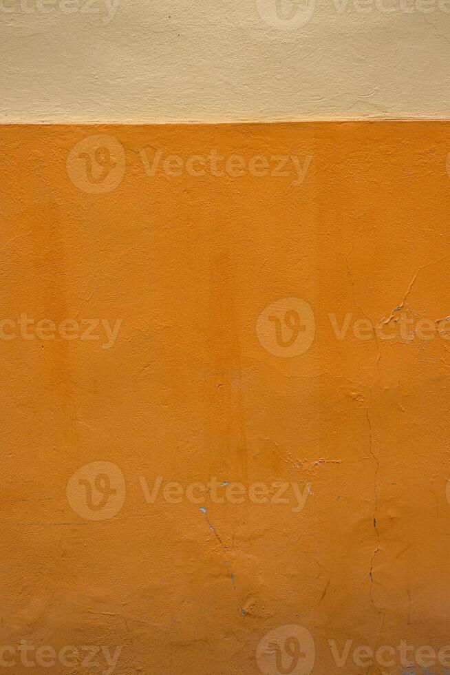 Vibrant orange wall texture with a subtle beige stripe, perfect for background, design inspiration or artistic project. Image of imperfections and unique details of an outdoor painted surface. photo