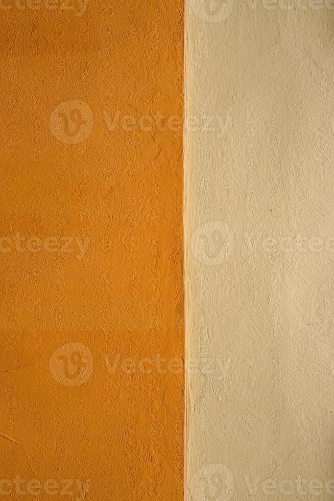 Vibrant orange wall texture with a subtle beige stripe, perfect for background, design inspiration or artistic project. Image of imperfections and unique details of an outdoor painted surface. photo