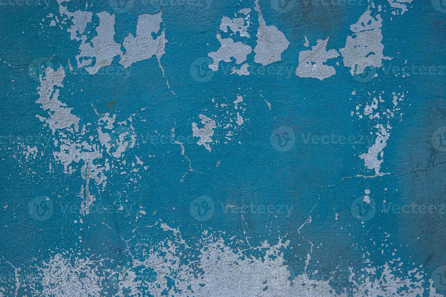 Peeling paint and cracked blue wall texture background. Weathered decayed urban surface with chipped paint and cracks. Distressed, rustic aesthetic for graphic design, web design, digital art. photo