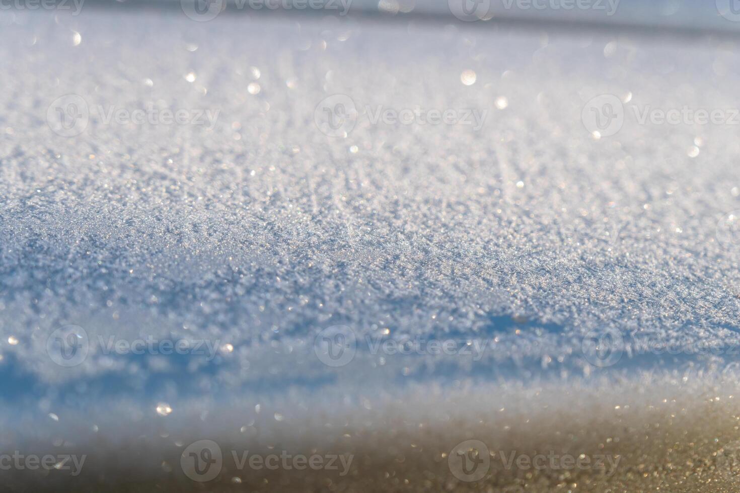 Selective focus. First frost on a frozen car, late autumn close-up. Beautiful abstract frozen microcosmos pattern. Freezing weather frost action in nature. Winter backdrop. photo