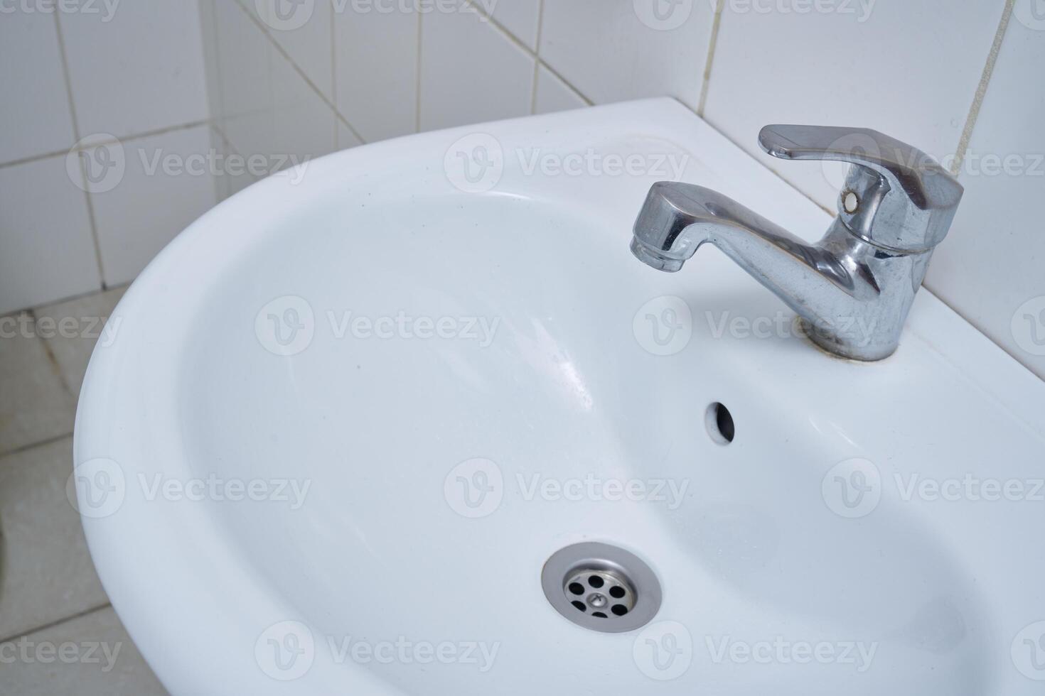 Toilet faucet and sink photo