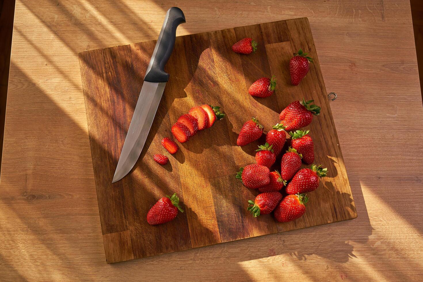 organic strawberries on a wooden cutting board photo