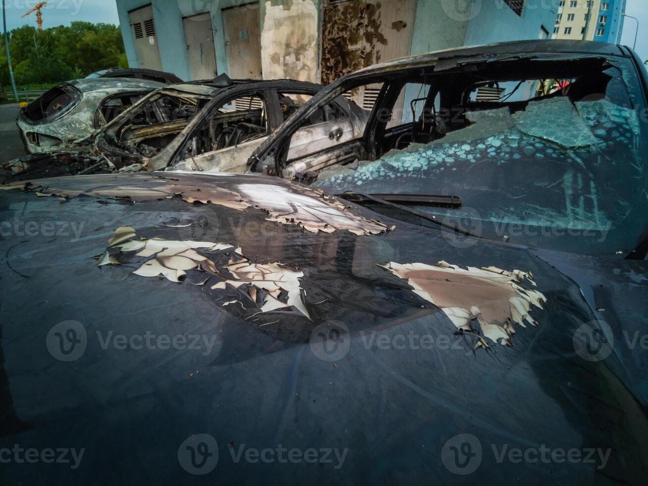 A cropped front view of a burned and abandoned rusty cars photo