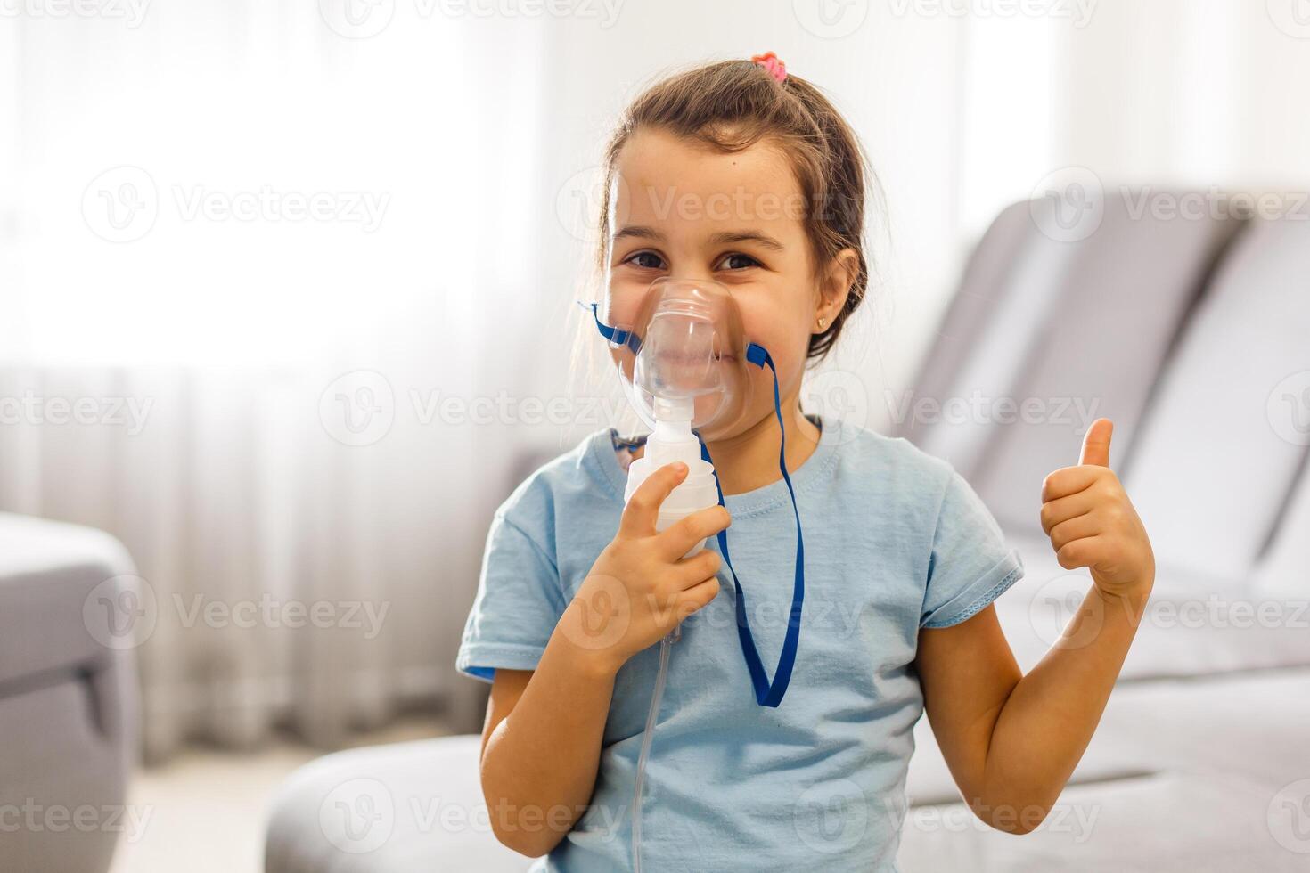 Little girl use inhaler nebulizer. Child asthma inhaler, nebulizer steam, flu or cold concept. Copyspace photo