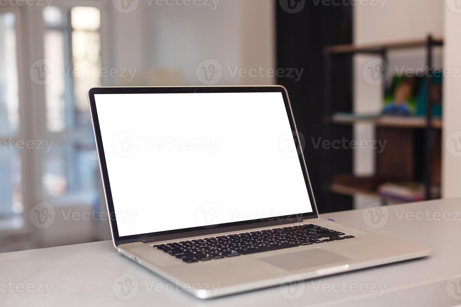 Cropped shot of portable office desk with mock-up computer devices, supplies and decorations on white table. photo