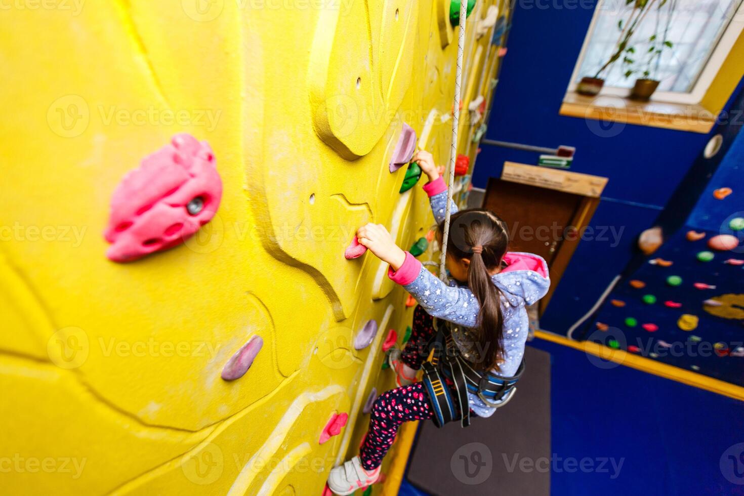 Little Girl Climbing Rock Wall photo