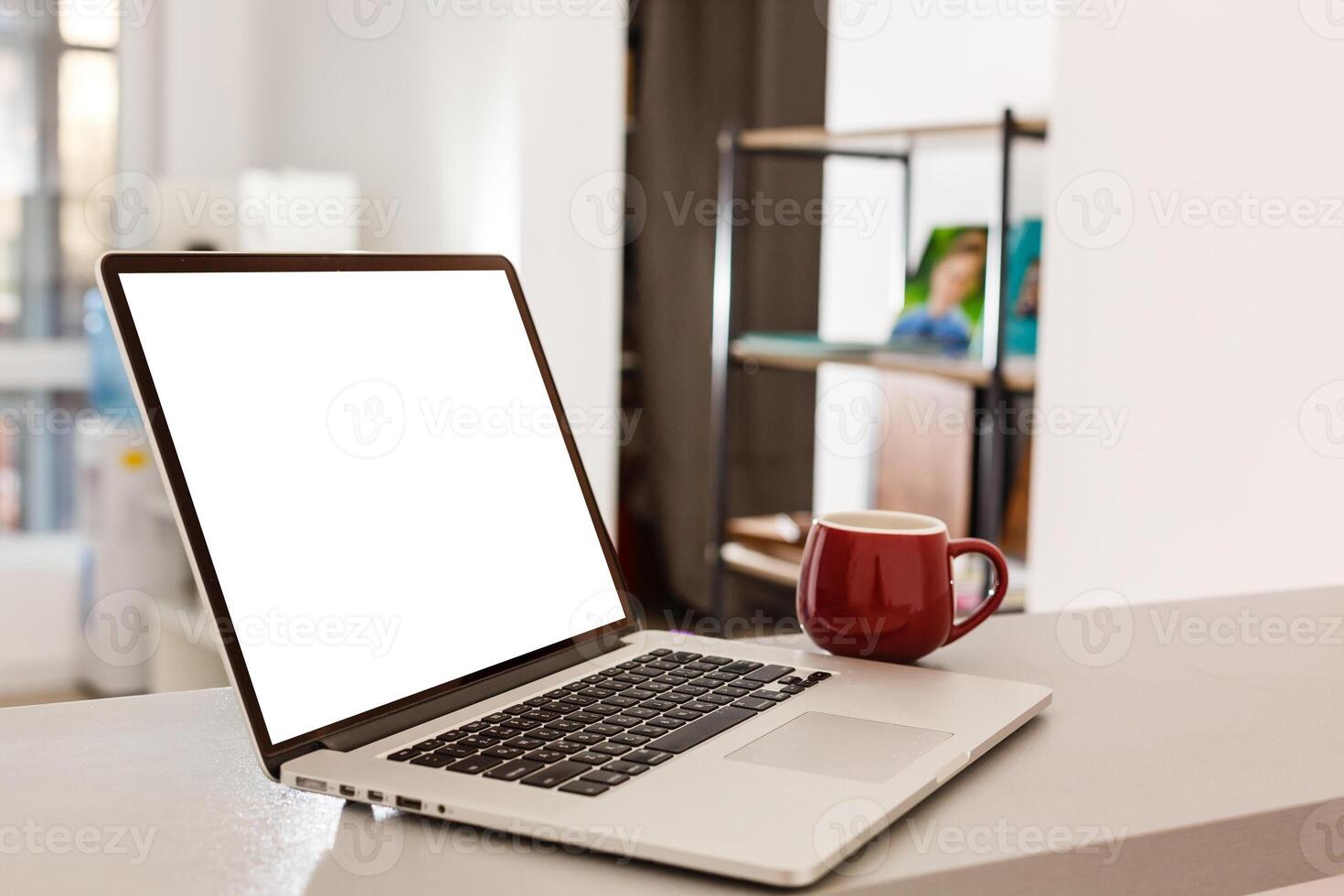 Cropped shot of portable office desk with mock-up computer devices, supplies and decorations on white table. photo