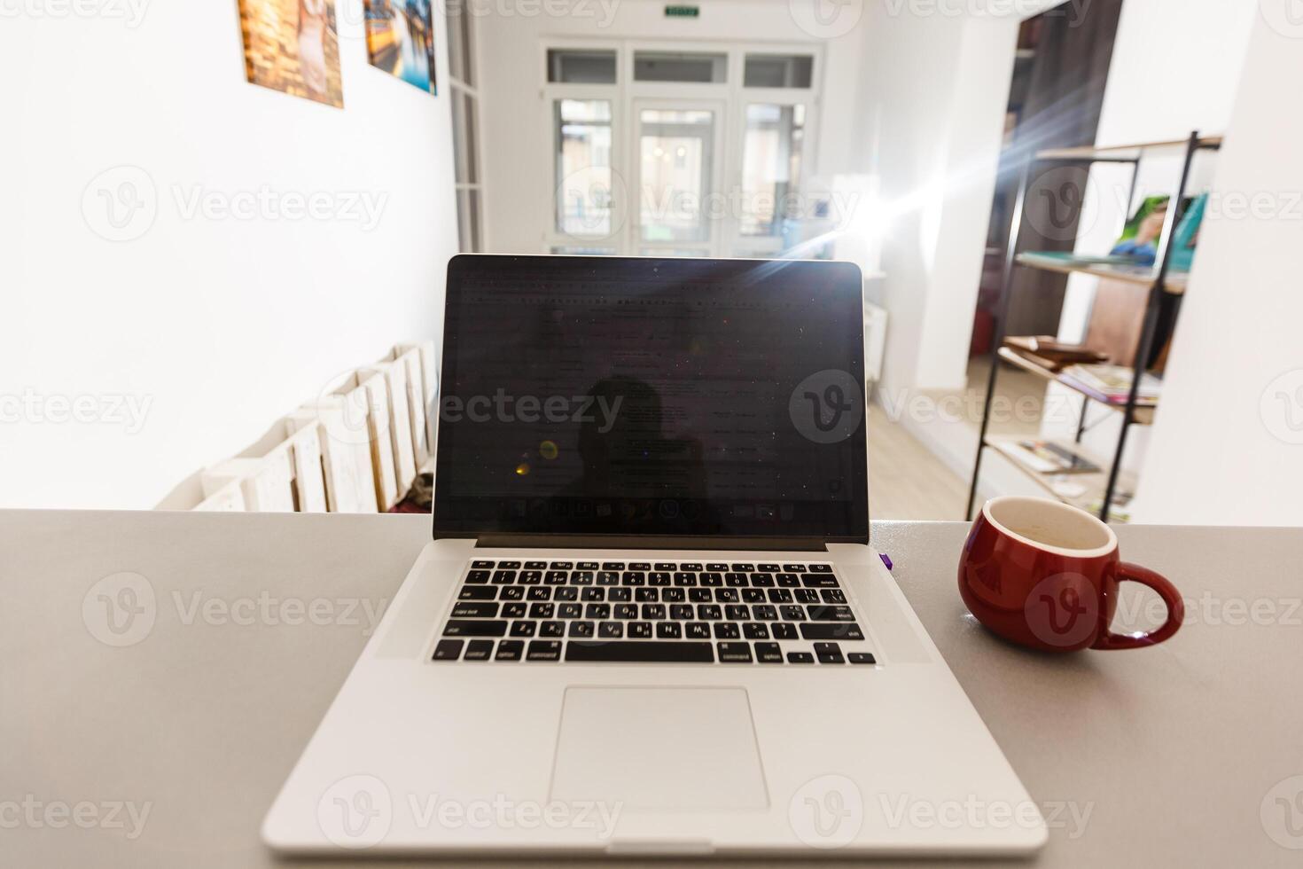 Cropped shot of portable office desk with mock-up computer devices, supplies and decorations on white table. photo