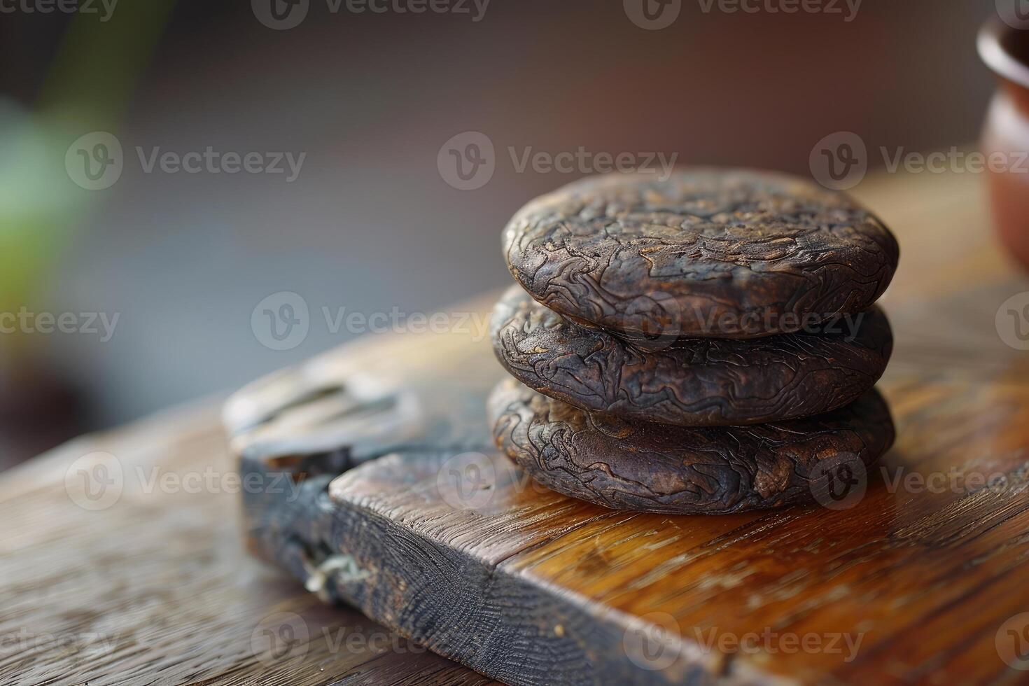 Aged puerh tea cakes on wooden surface photo