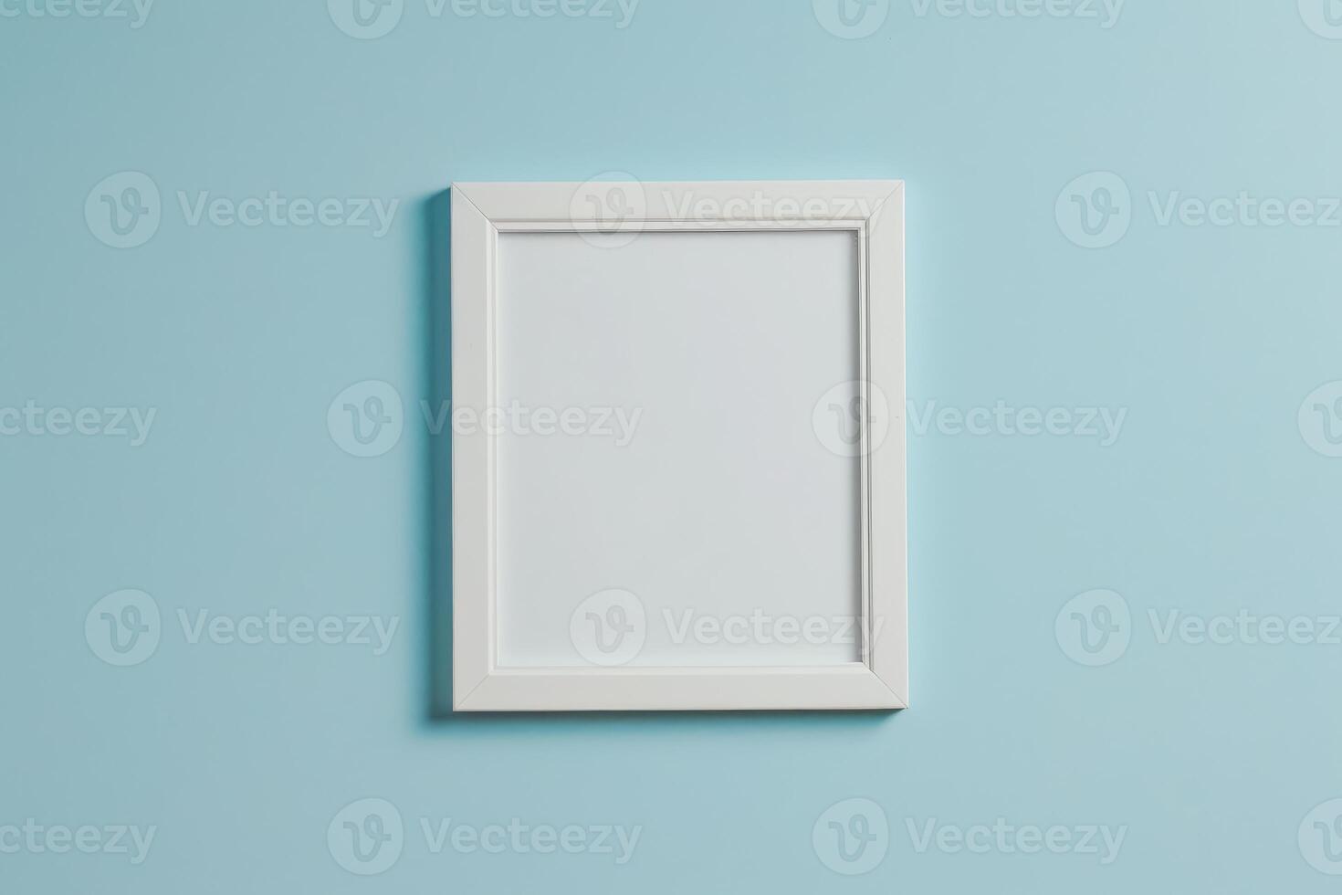 Minimalist white picture frame on blue wall photo