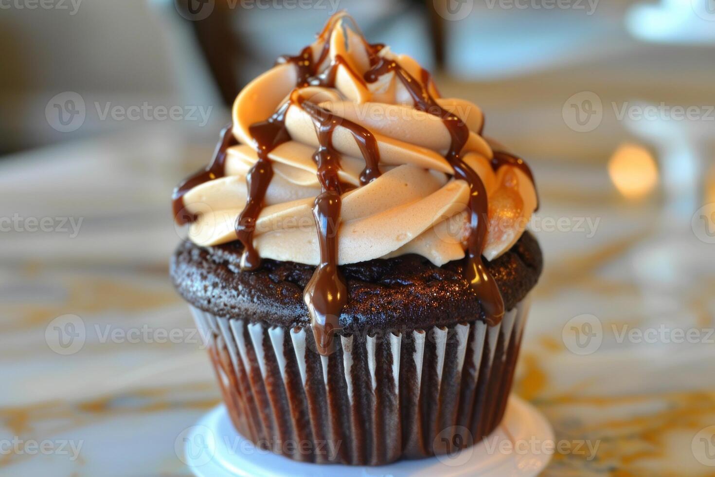 Delicious chocolate cupcake drizzled with chocolate and peanut butter frosting photo