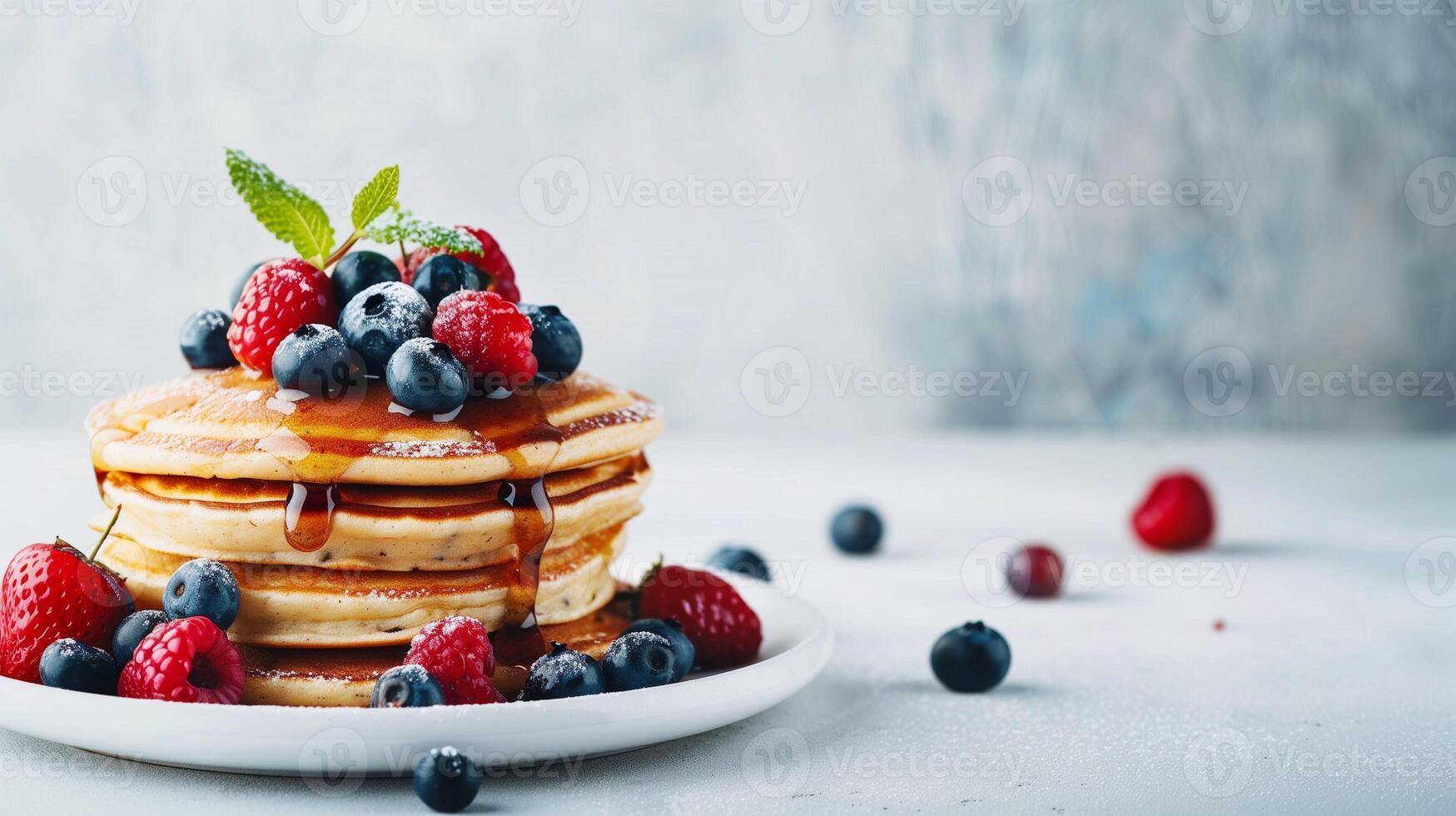 Delicious Stack of Fluffy Pancakes Topped With Fresh Berries and Maple Syrup on a Light Background photo