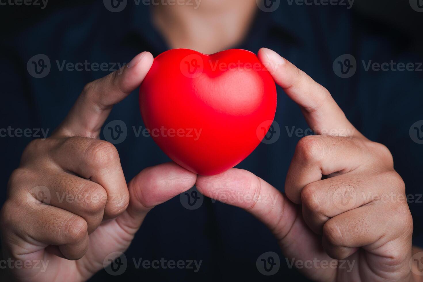 Hands of holding red heart shape. Close-up photo. Sign of love, healthcare, valentine's day, world heart day concept photo