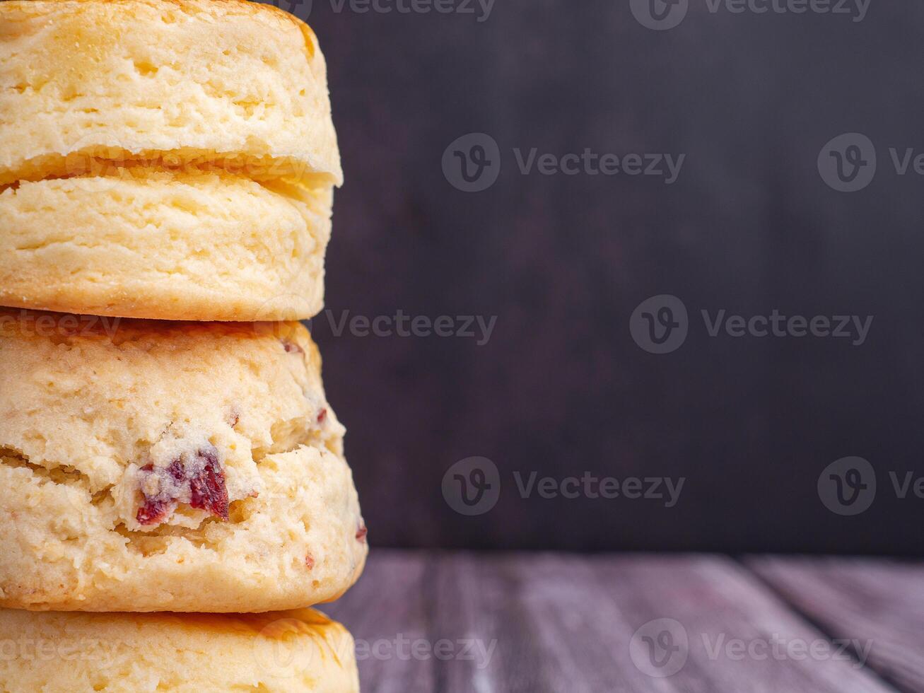Scones traditional English delicious fresh homemade with dark vintage wall background. Close-up photo. Dessert, beverage, and relaxation concept photo