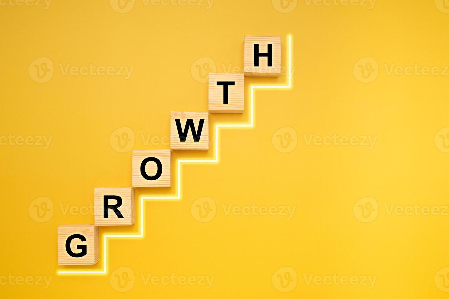 Business growth and investment concept. GROWTH word written on wooden cubes and light effect isolated on yellow background for connecting to the success process in business photo