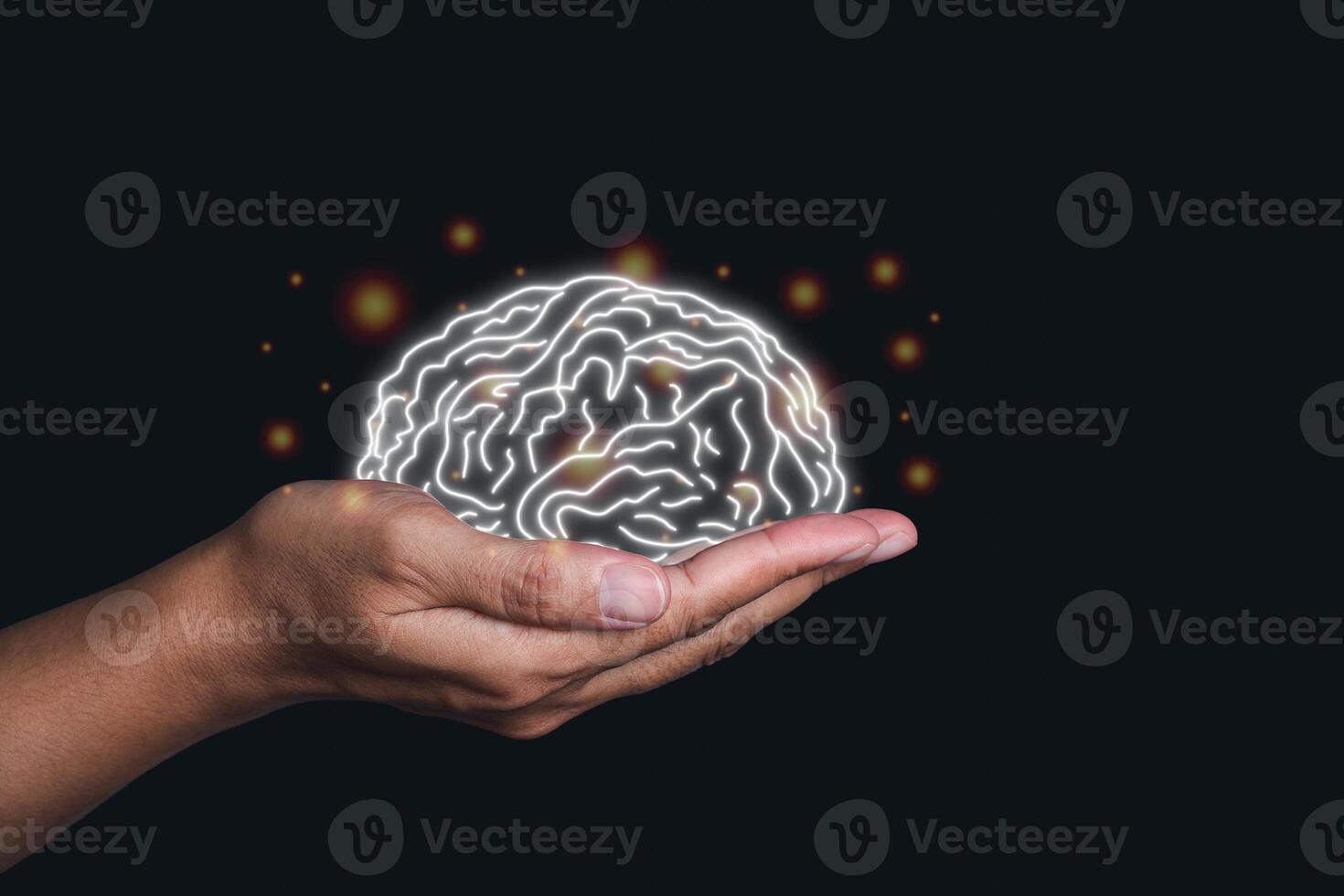 Hand holding a digital image of the brain in the palm on black background. Mental health protection and care.. photo