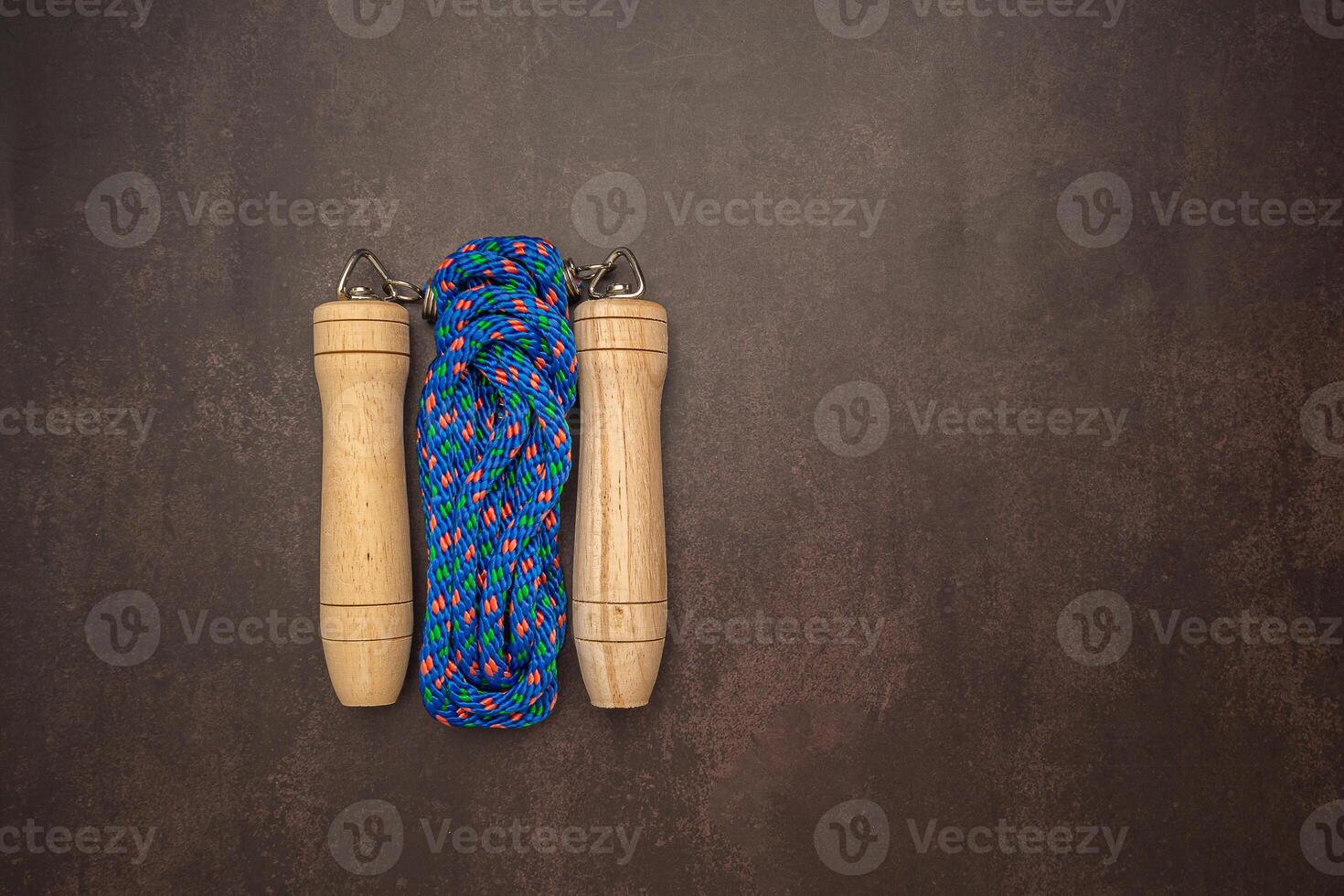 Top view of Jumping rope on vintage background. Space for text photo