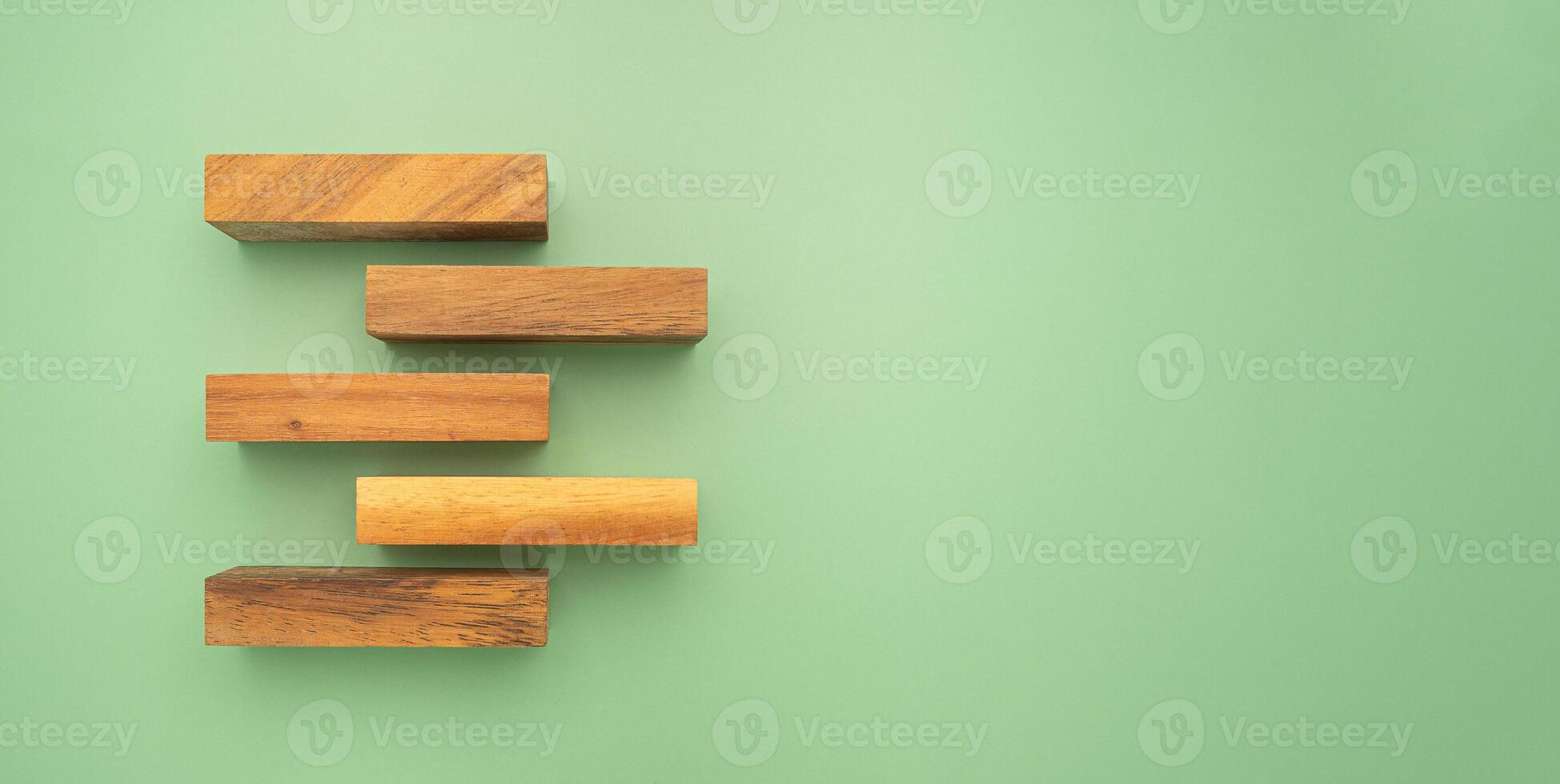 Top view of wooden blocks isolated on a green background photo