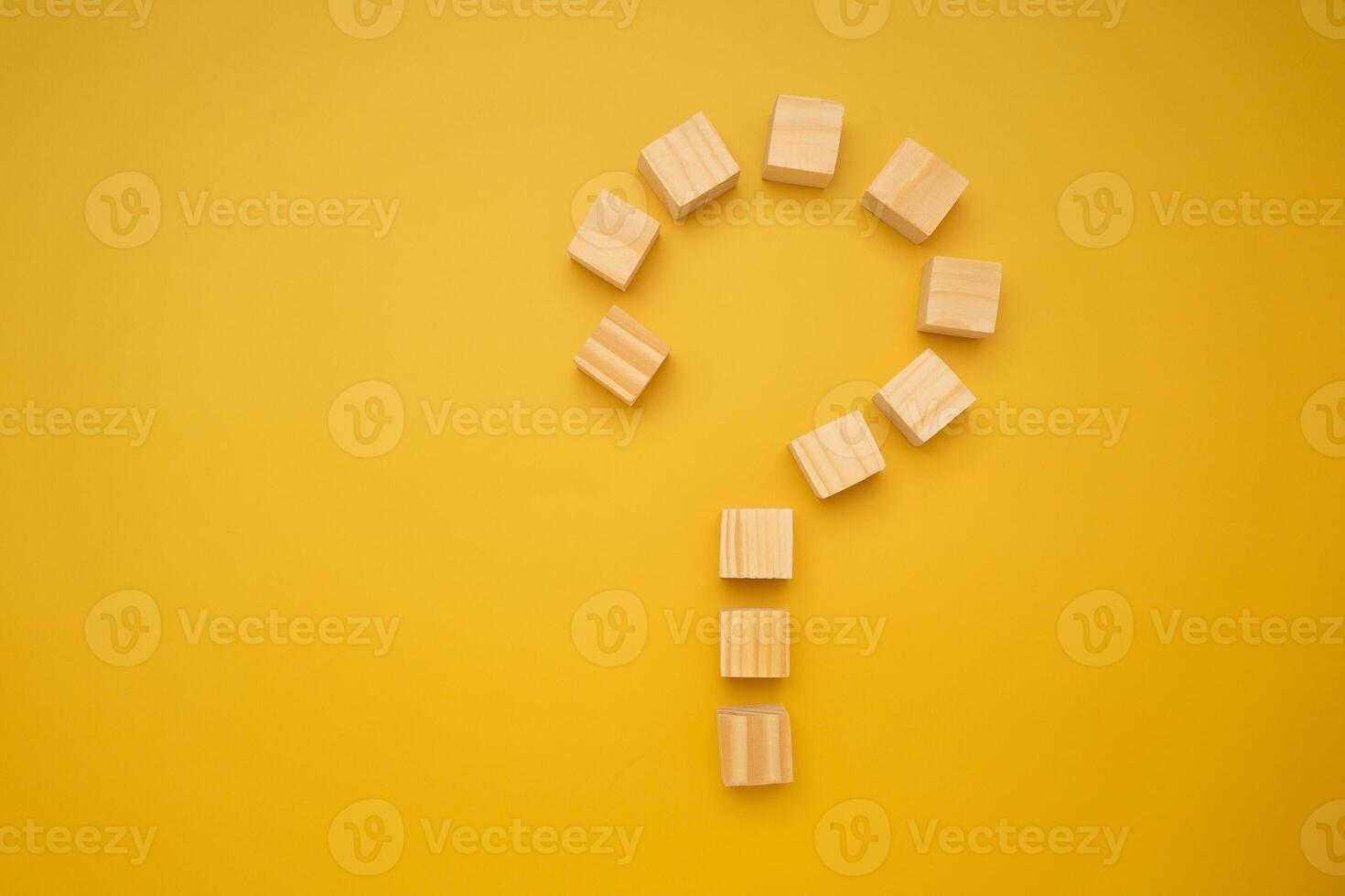 Question mark concept with arranging wooden blocks isolated yellow background with space for text photo