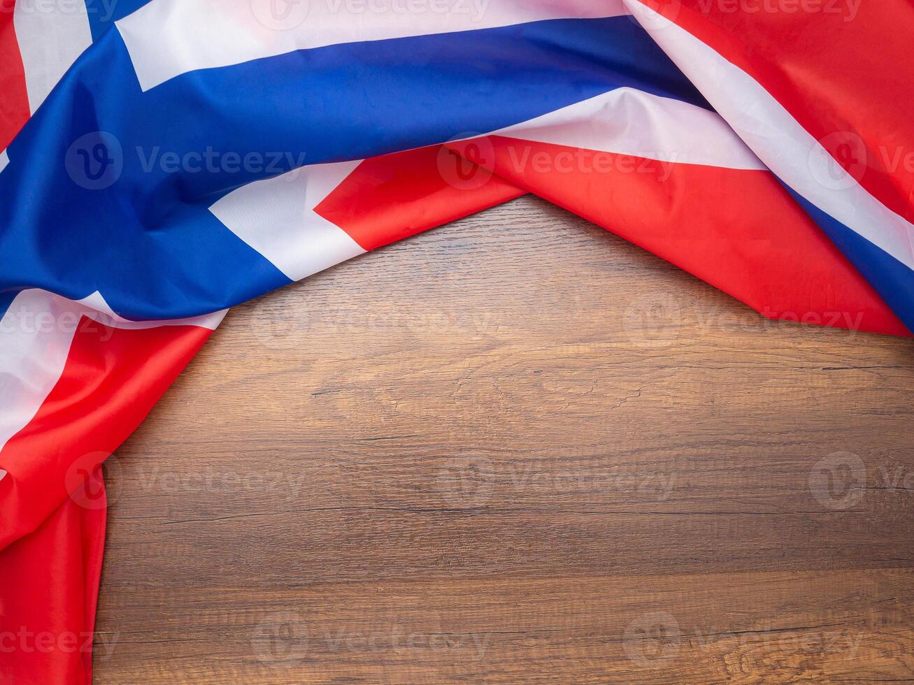 Top view of the Norway flag on a wooden table with space for text. Close-up photo