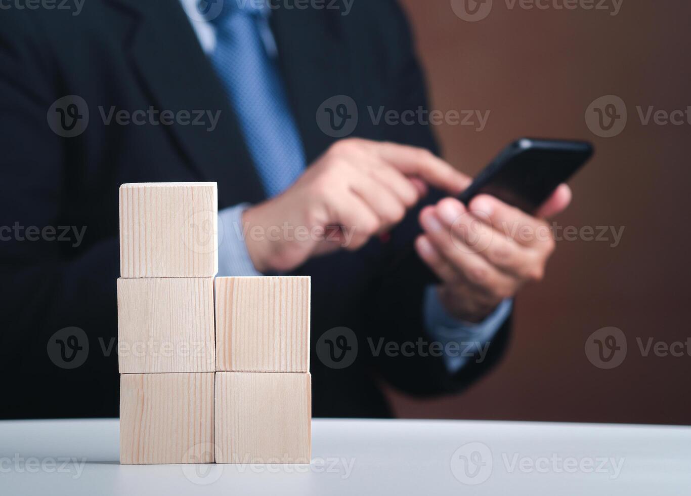 Hand of businessman arranging empty wooden blocks. Close-up photo. Space for text. Business and strategy planning concept photo