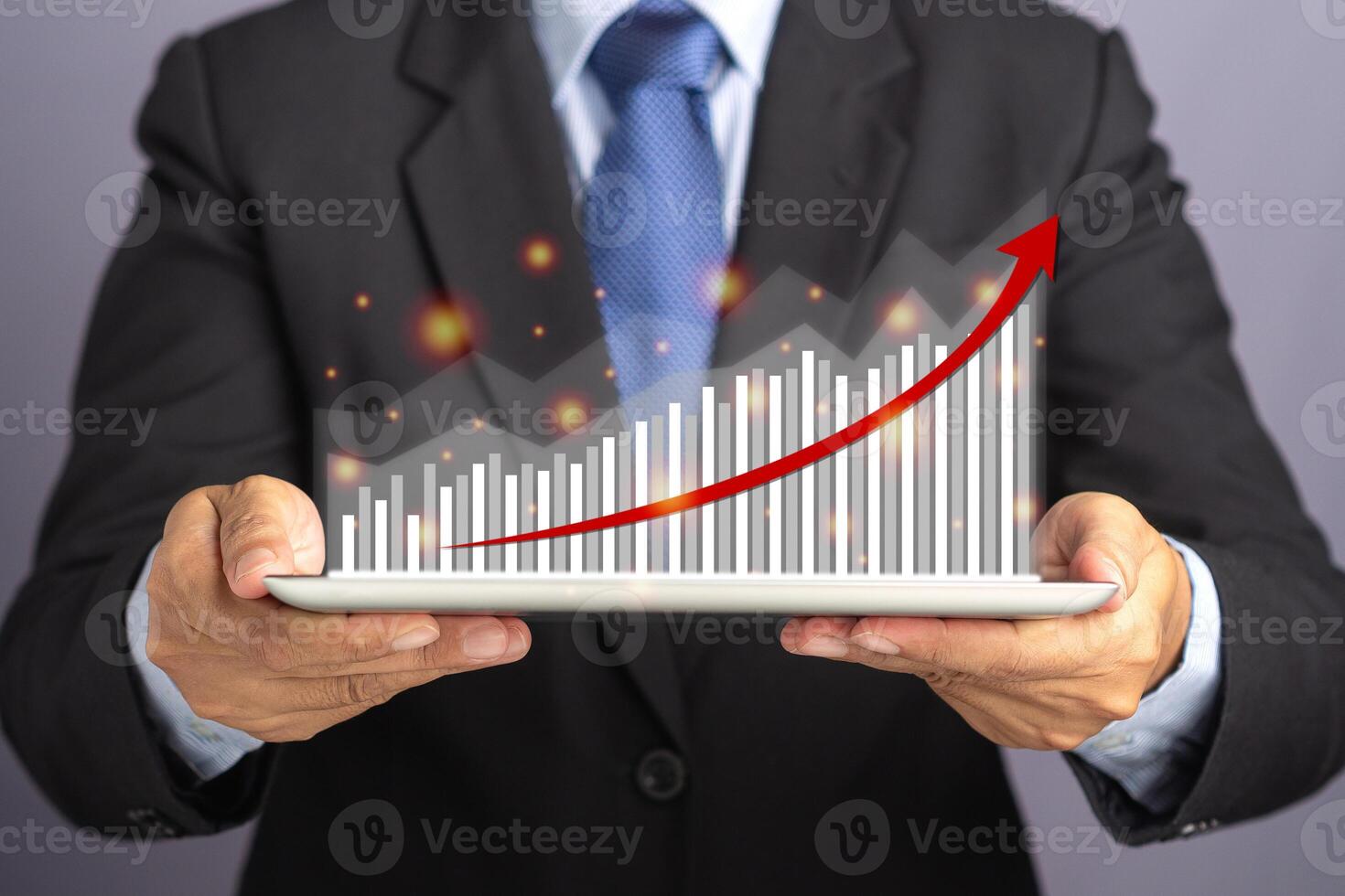 Businessman hand holding of tablet and showing a graph of statistics with arrow up. Stock market investments funds and digital assets. Business finance technology and investment concept photo