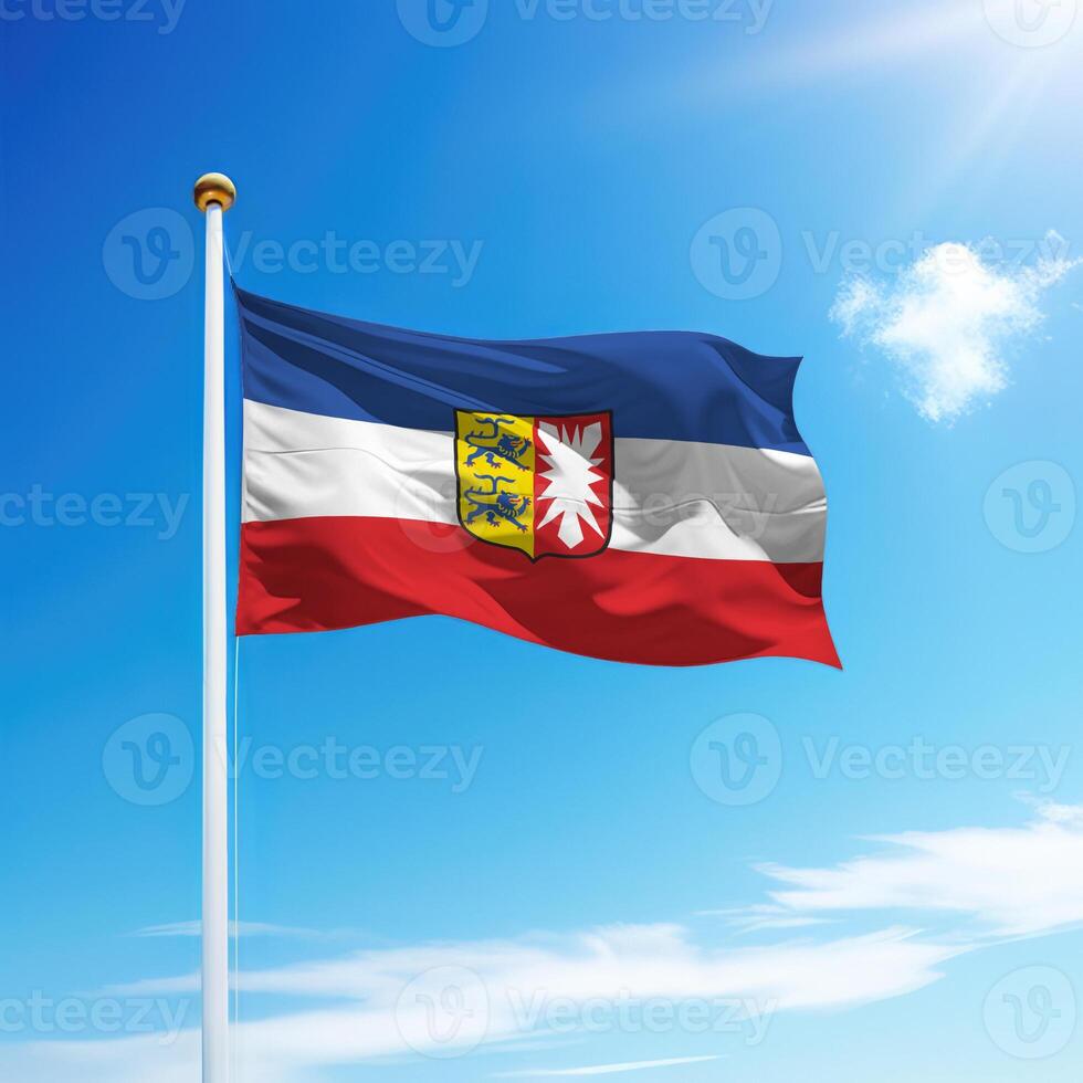 Waving flag of Schleswig-Holstein is a state of Germany on flagpole photo