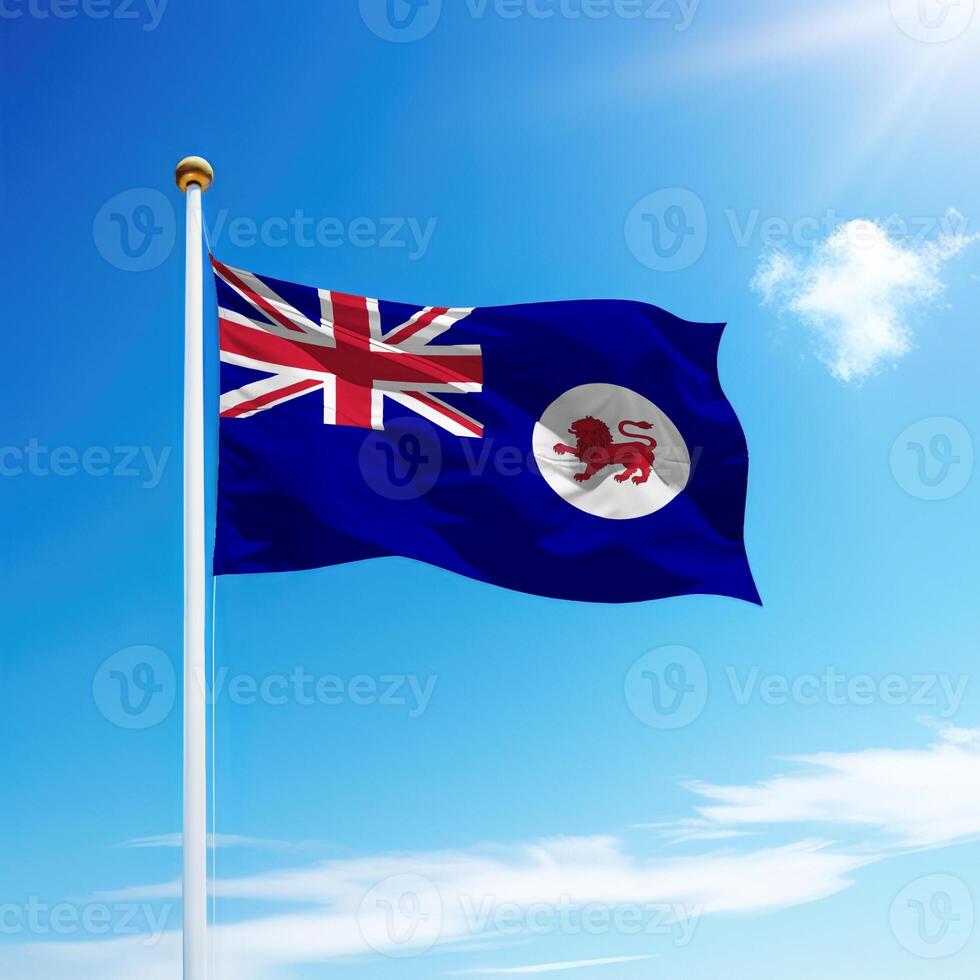 Waving flag of Tasmania is a state of Australia on flagpole photo
