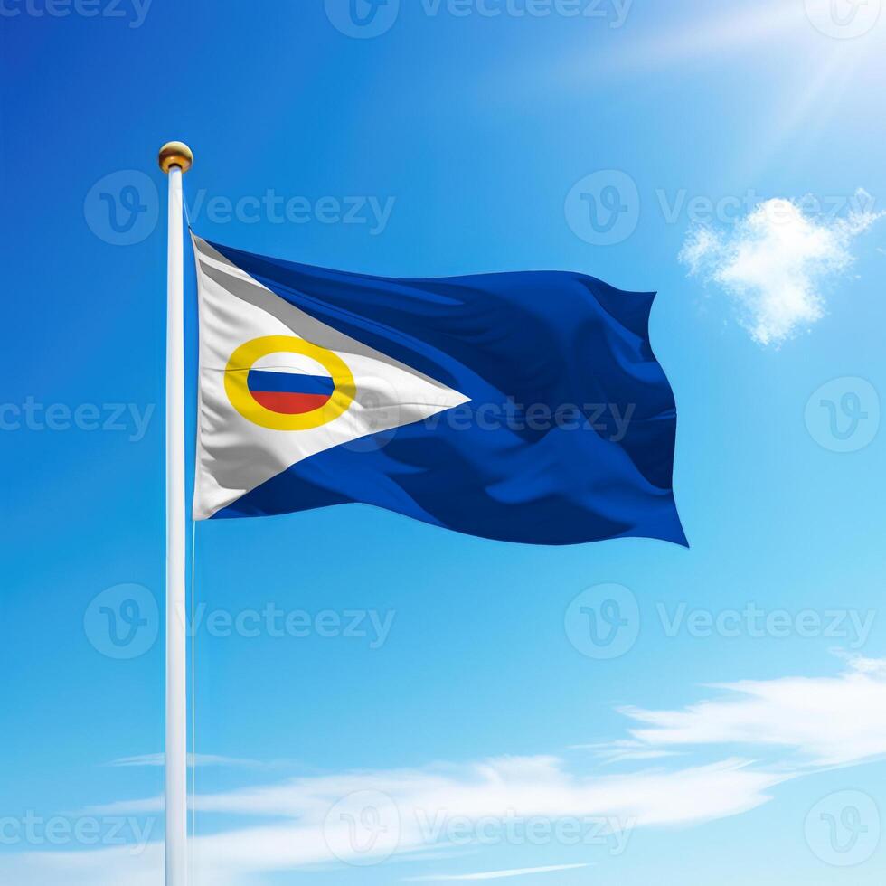 Waving flag of Chukotka is a region of Russia on flagpole photo