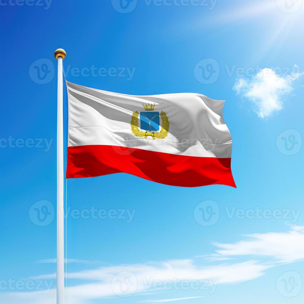 Waving flag of Saratov is a region of Russia on flagpole photo