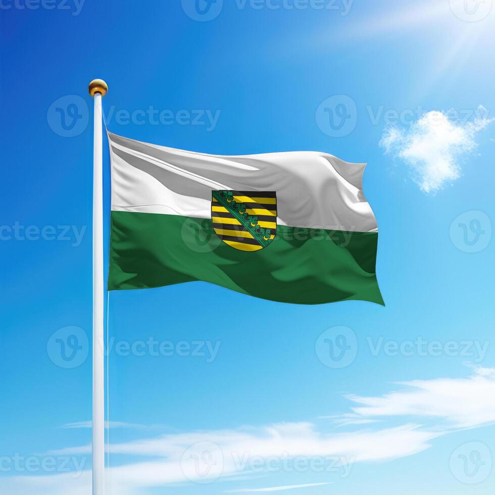 Waving flag of Saxony is a state of Germany on flagpole photo
