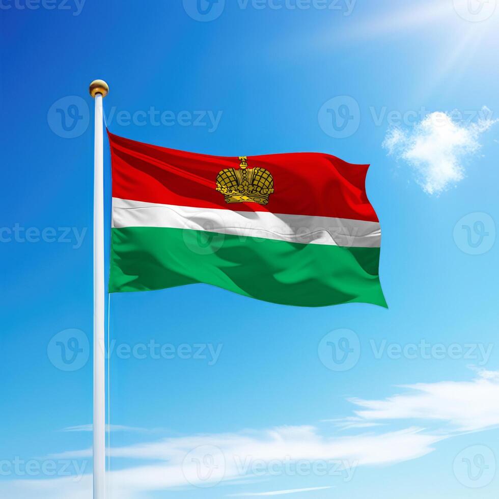 Waving flag of Kaluga is a region of Russia on flagpole photo