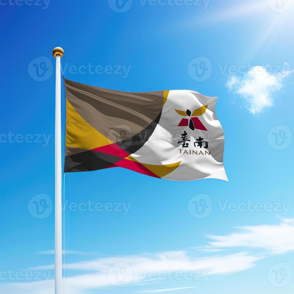 Waving flag of Tainan City is a region of Taiwan on flagpole photo