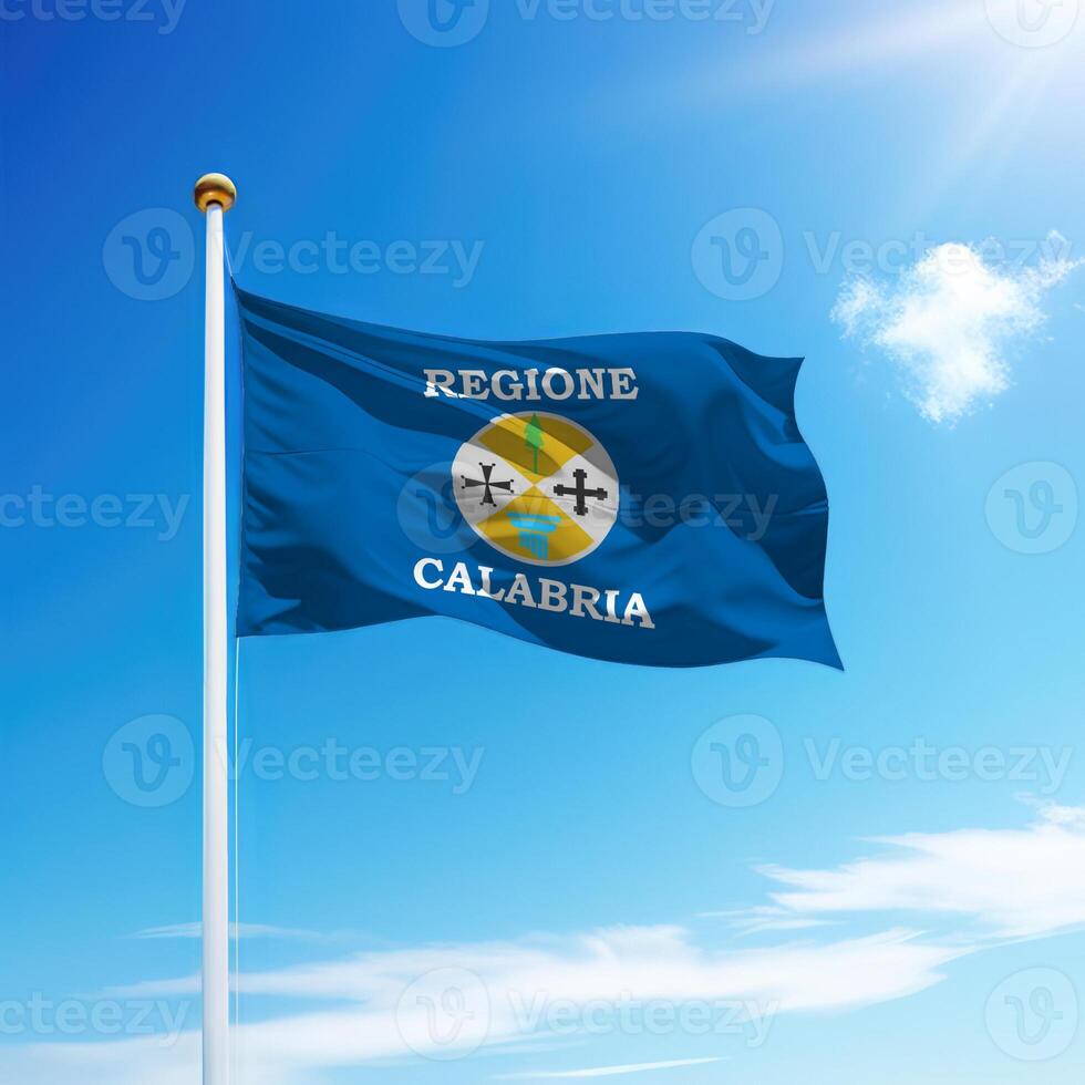 Waving flag of Calabria is a region of Italy on flagpole photo