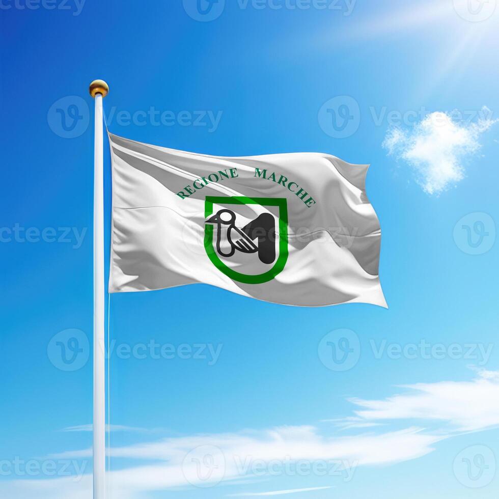 Waving flag of Marche is a region of Italy on flagpole photo