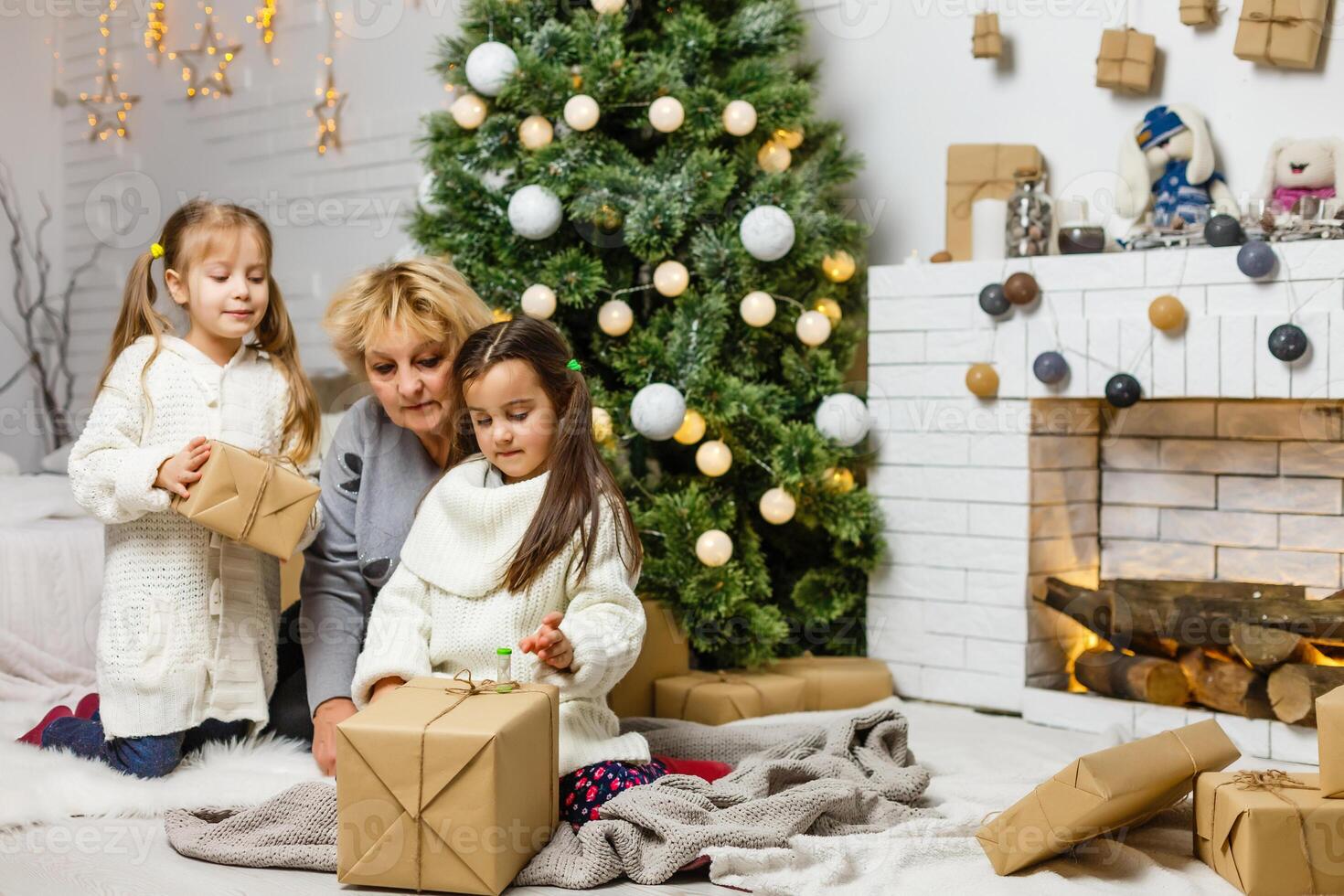 grandparents and children having fun during christmas day celebration at home with family photo