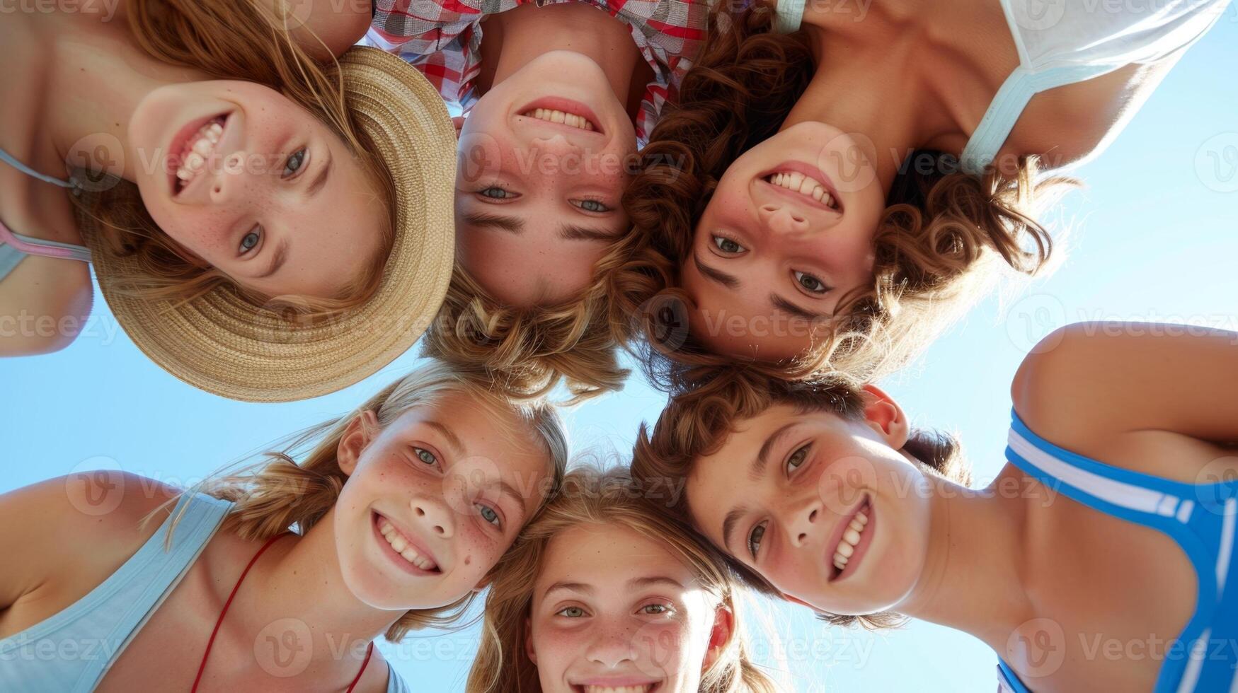 Group of kids forming a circle and smiling to camera photo