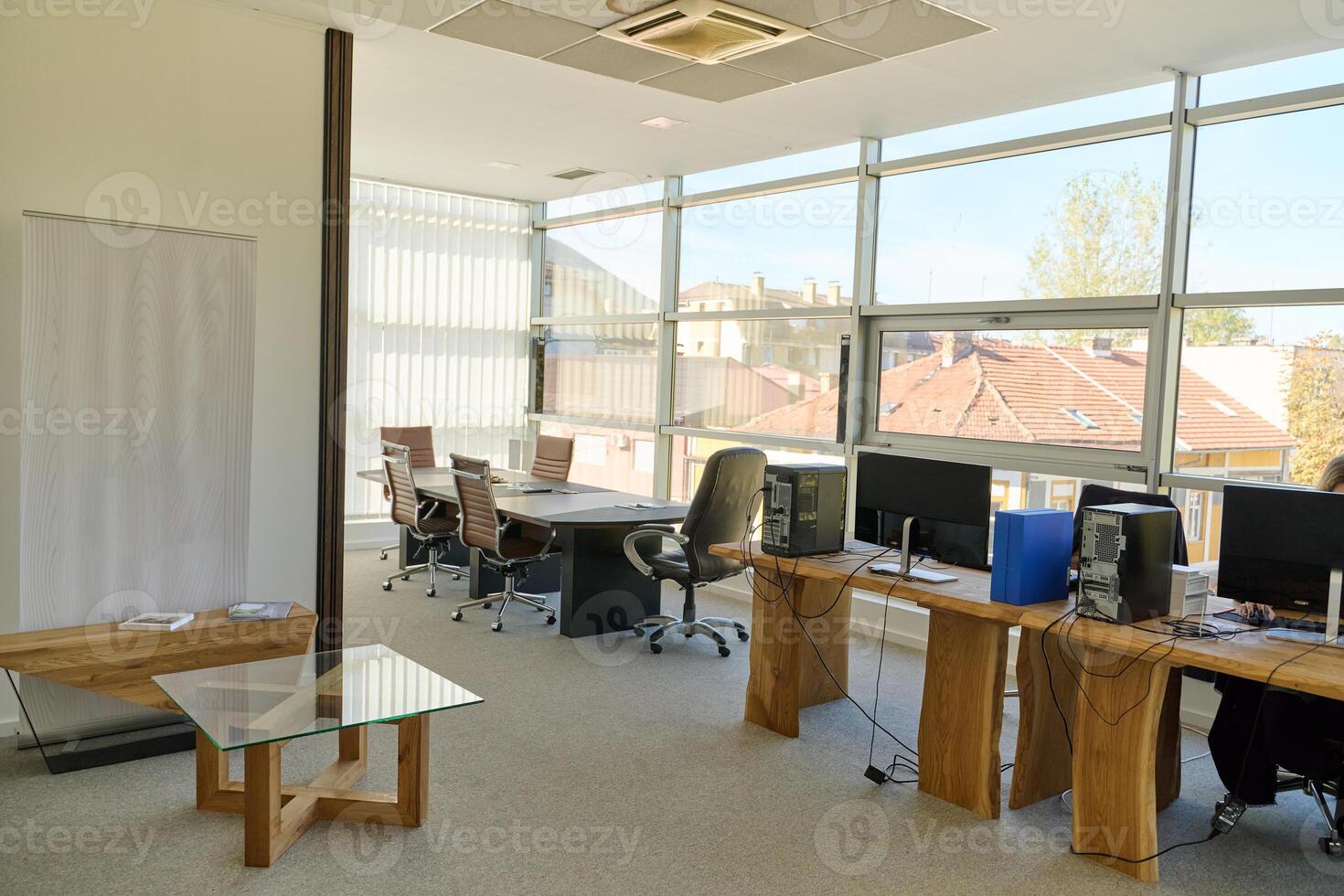 Modern Office Interior with Wooden Furniture, Conference Table, and Computers photo