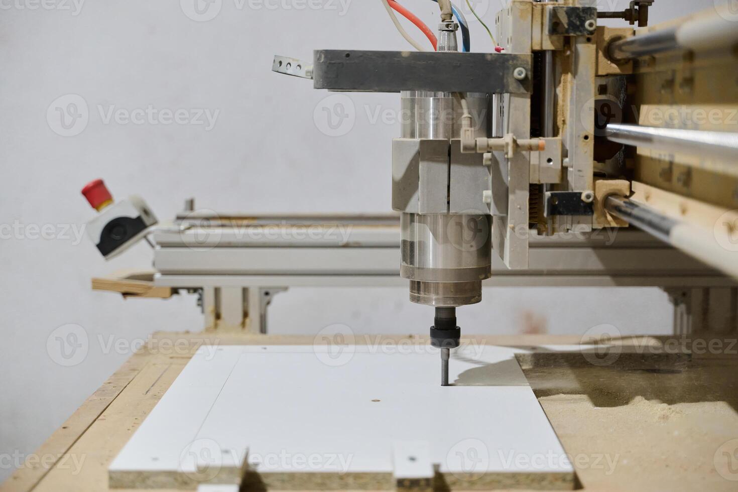 Close-Up of CNC Machine Precisely Cutting and Processing Wooden Boards photo