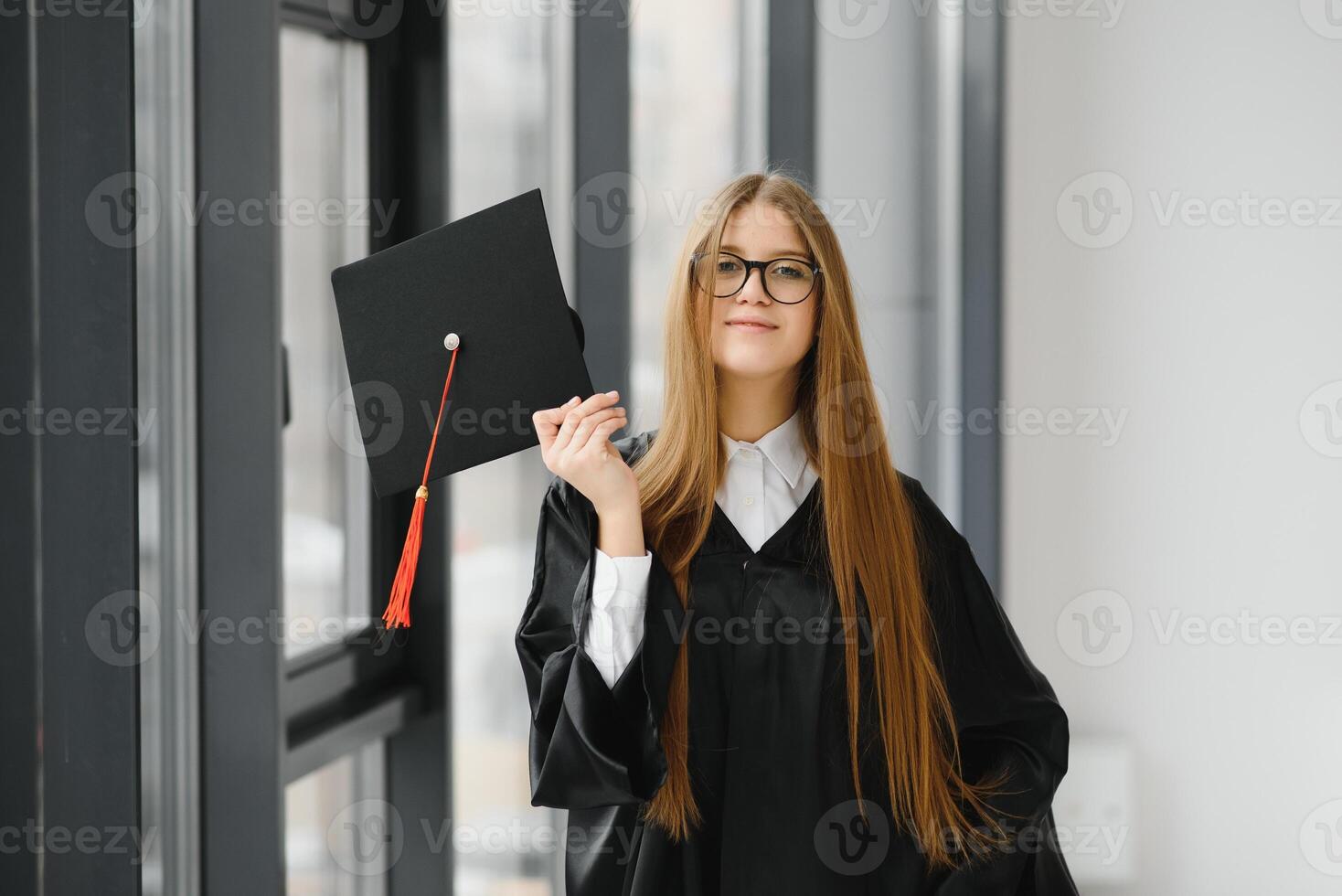 Educational theme graduating student girl in an academic gown. photo