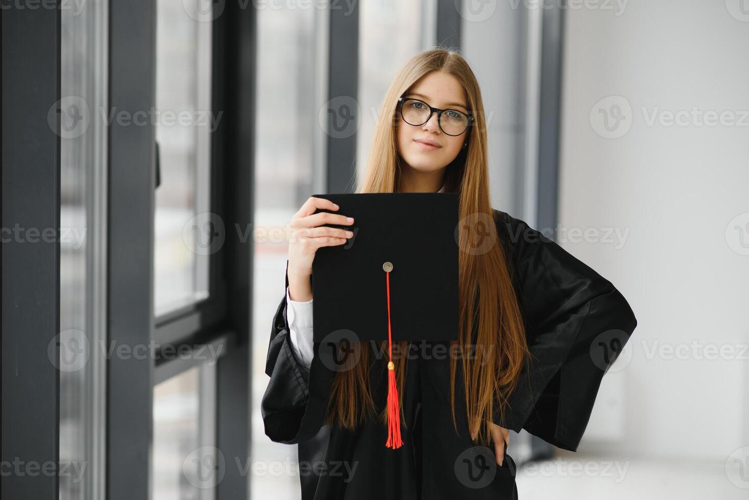 Educational theme graduating student girl in an academic gown. photo