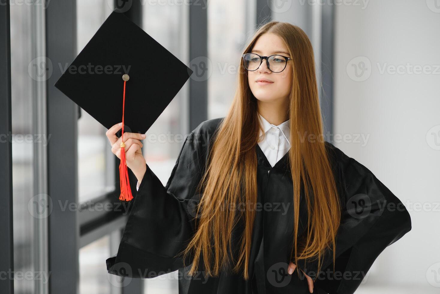 Educational theme graduating student girl in an academic gown. photo
