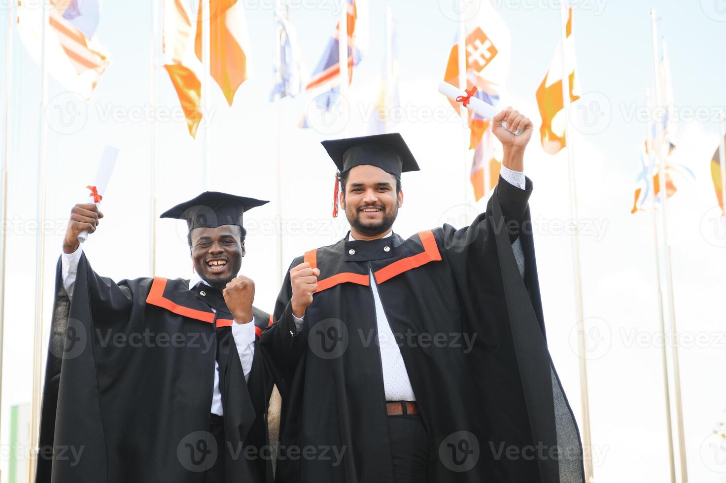Two friends are university graduates. Indian and African graduates photo
