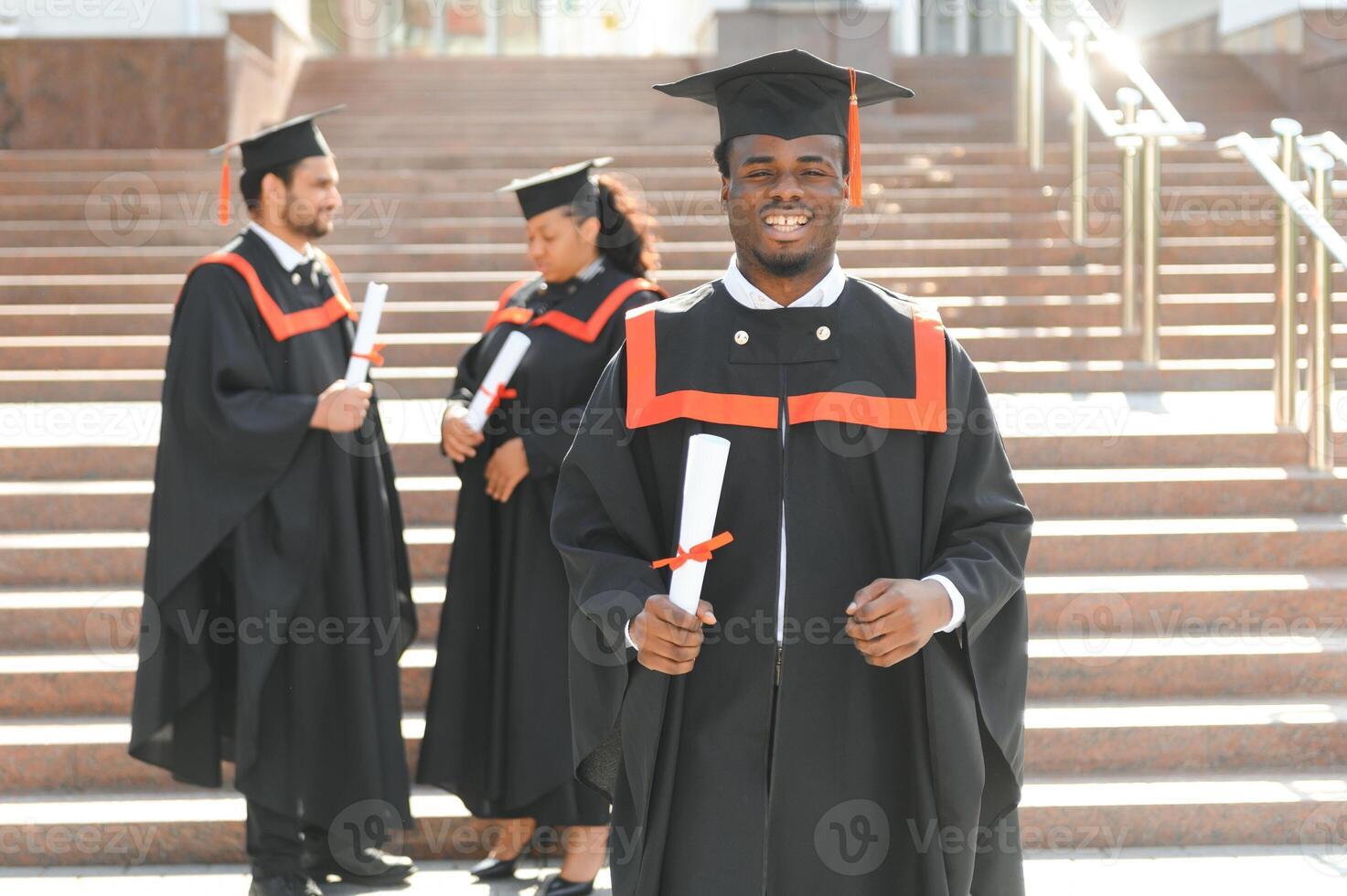 Happy graduate. Happy African man in graduation gowns photo