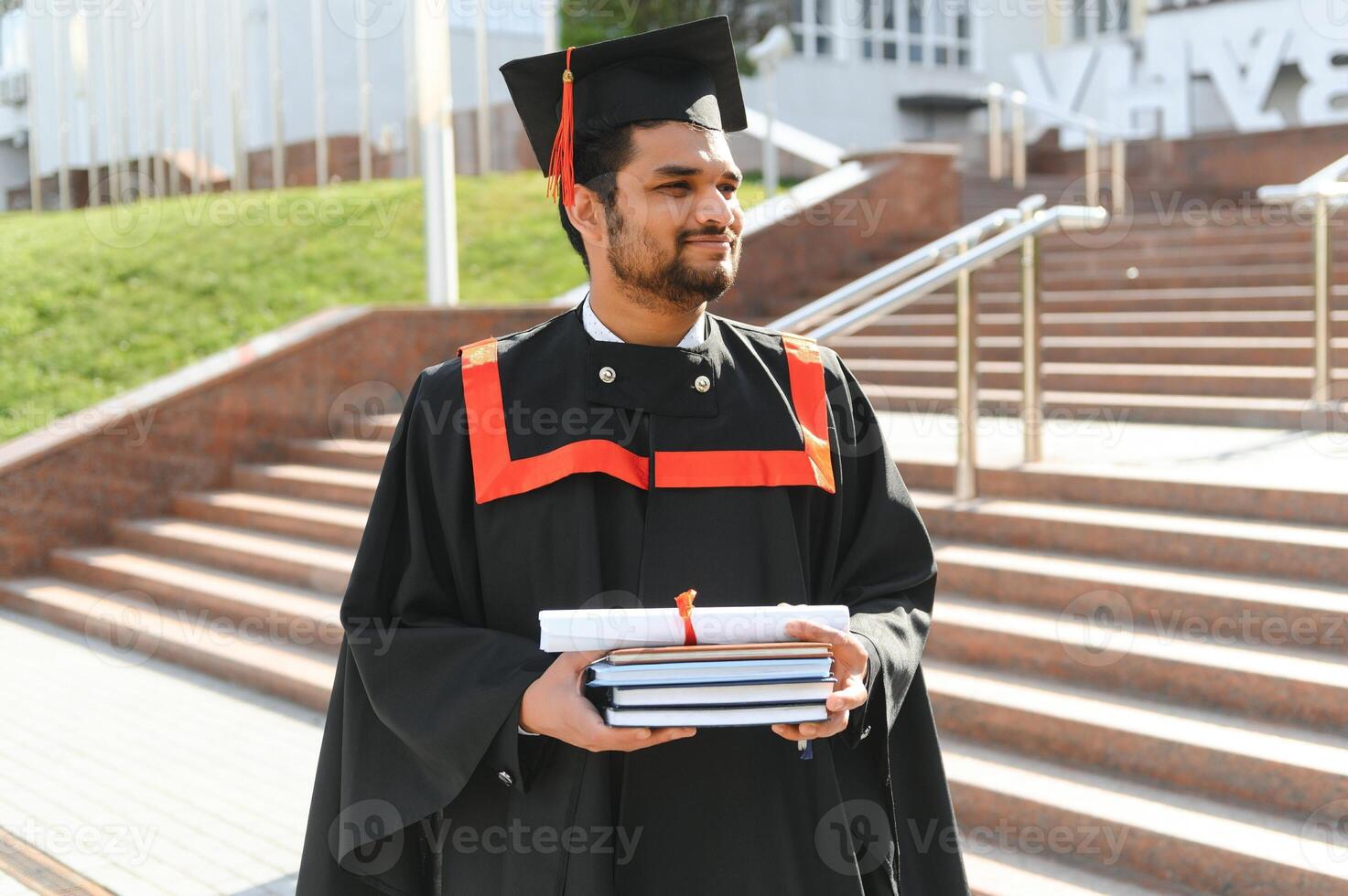 Portrait of happy man, graduation or student in university campus photo