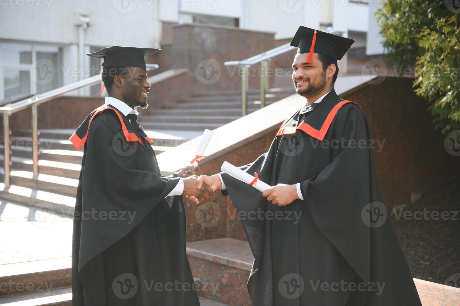 Happy boys students university graduates. Multiracial students photo